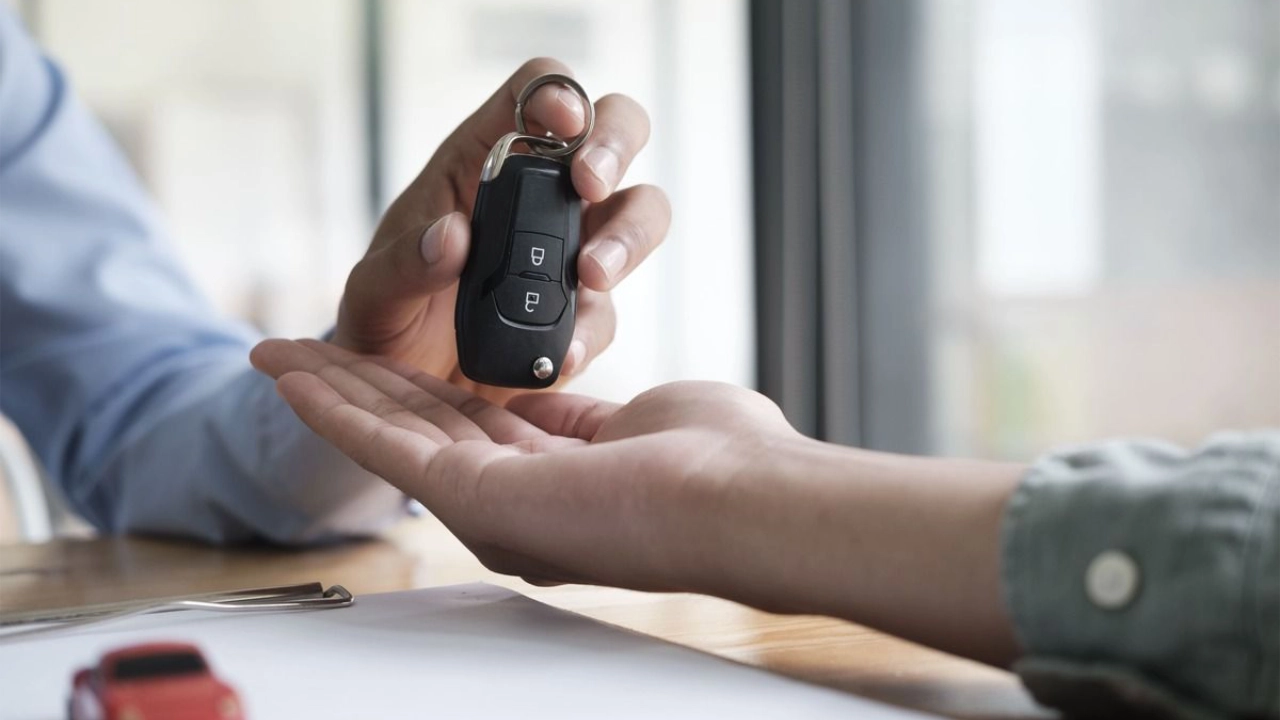 person receiving the keys of their new car