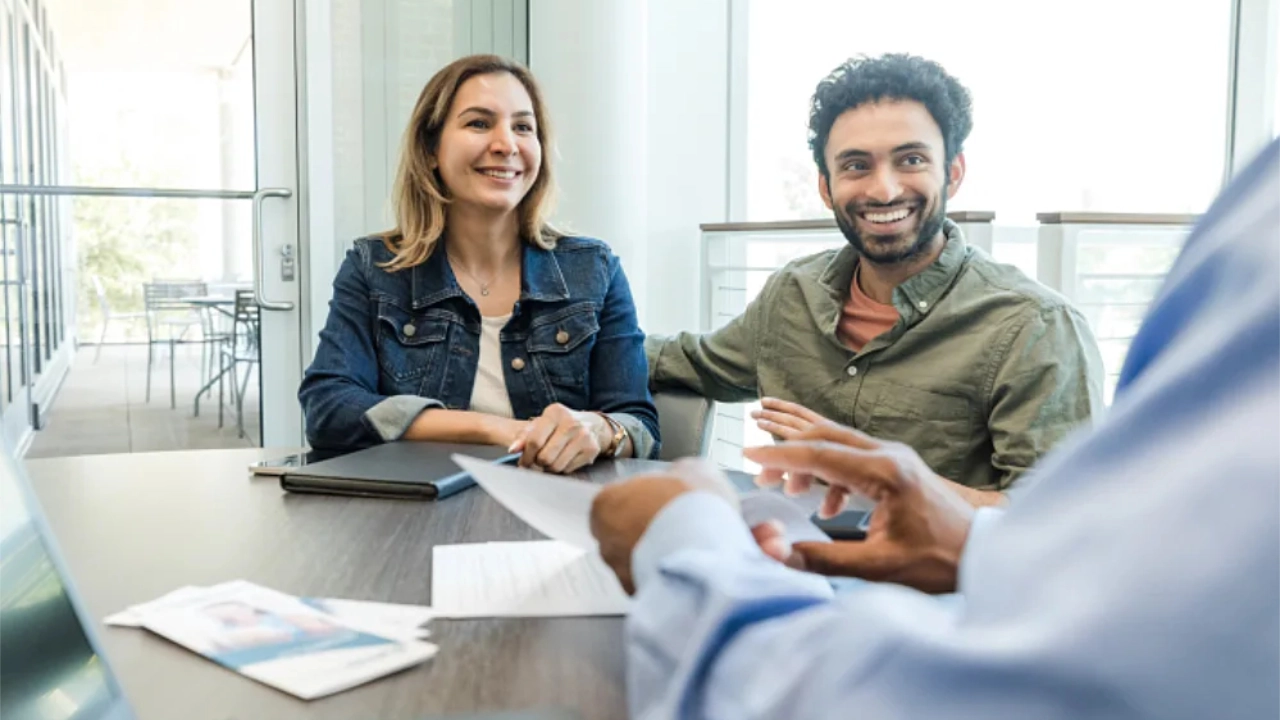 couple discussing at a table with a financial advisor