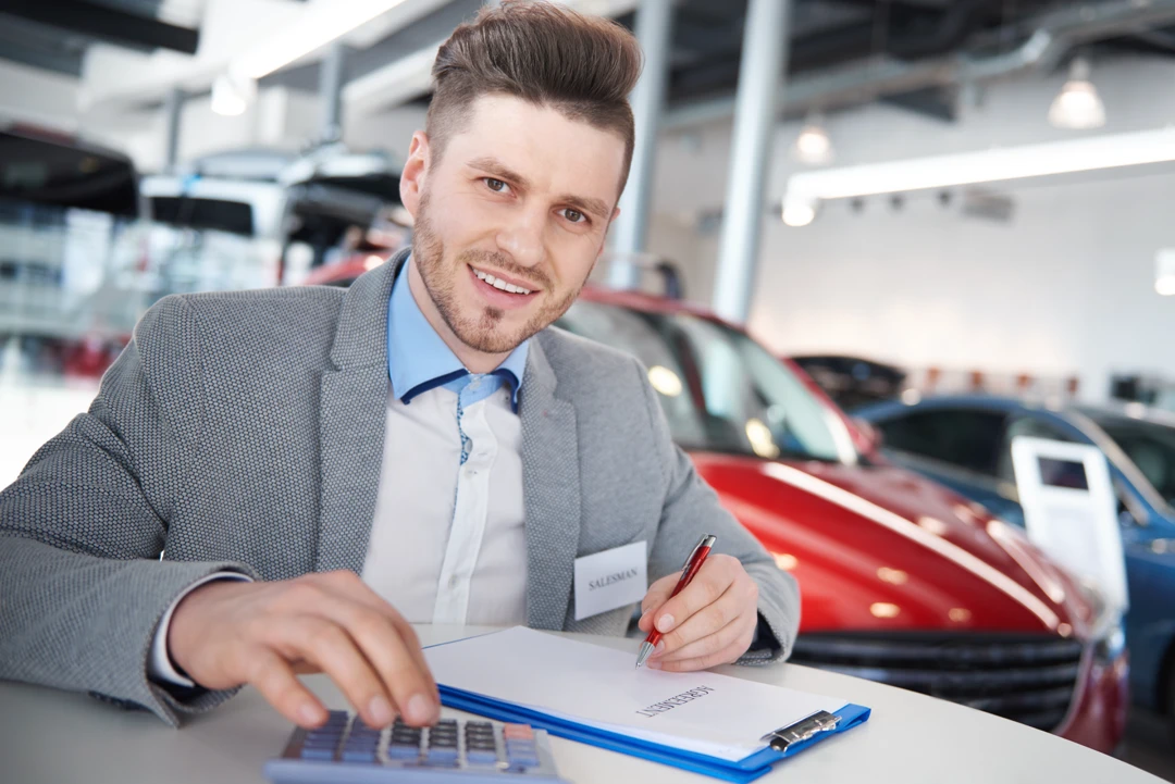 Automotive advisor reviewing documents to assess a car loan application without a credit history.