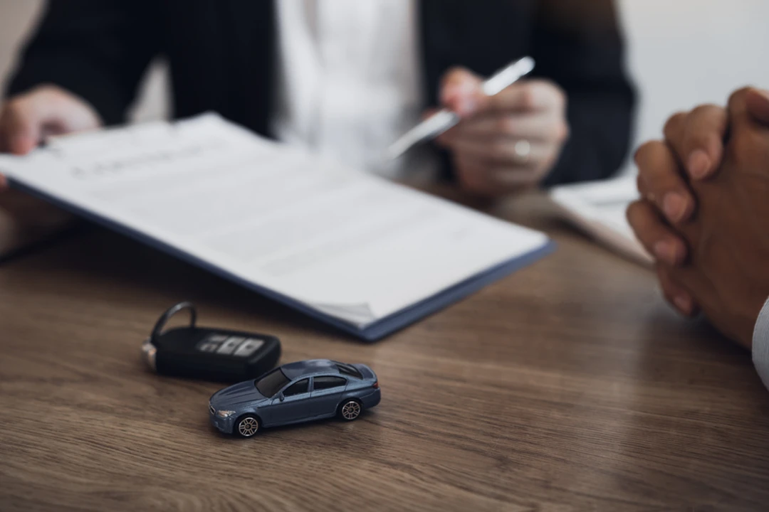 Advisor and customer reviewing an auto financing application following late payments.