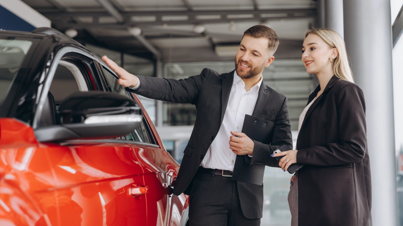 young woman shopping cars with the help of a sales representative