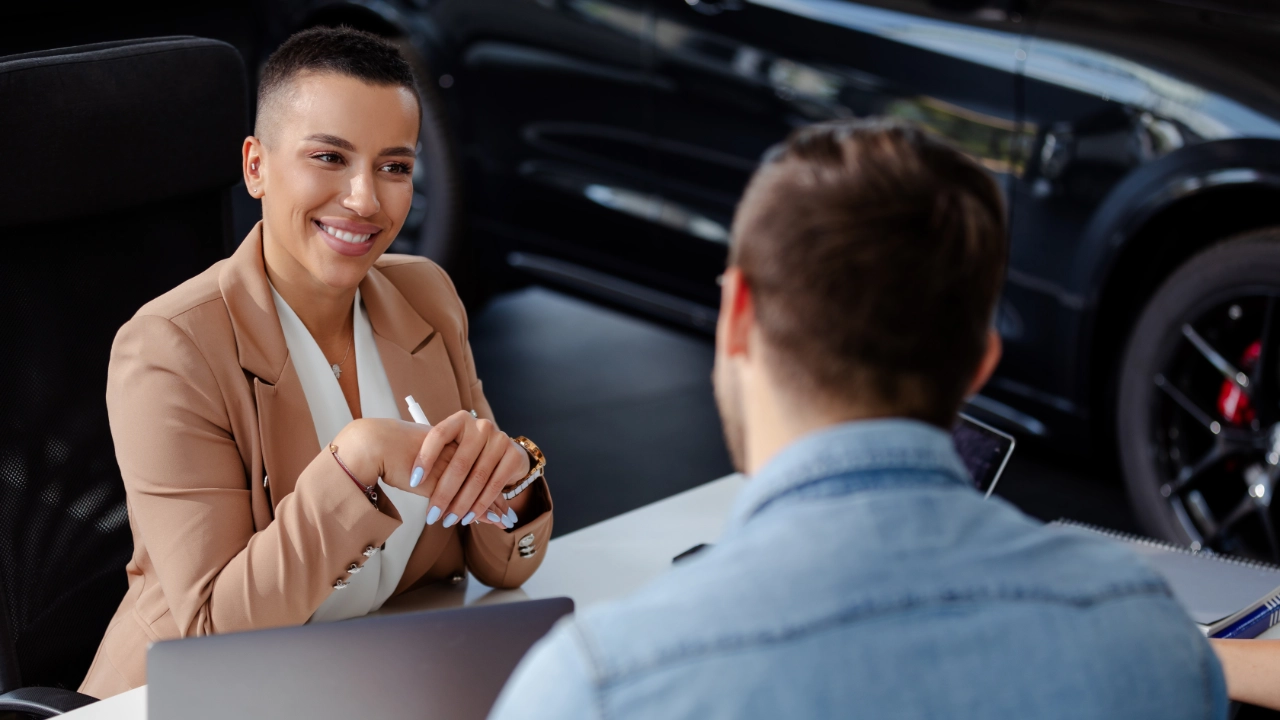 young man discussing with an advisor in a dealership