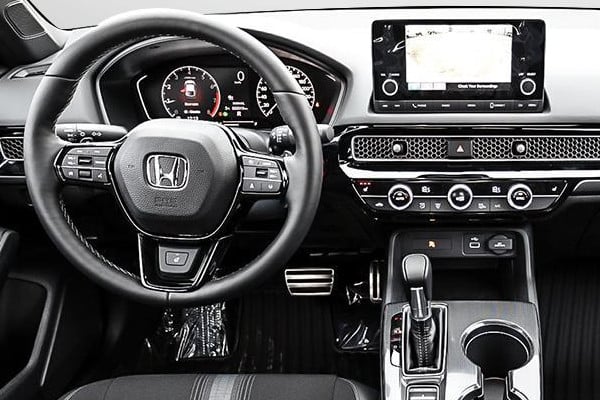 Close-up of 2023 Civic Hatchback Sport driver-side steering wheel and dashboard