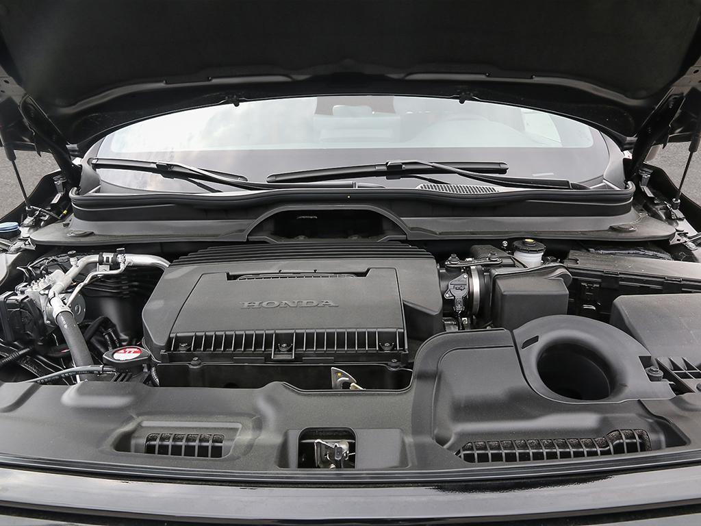 Engine compartment of a black 2026 Honda Passport TrailSport AWD with the hood open