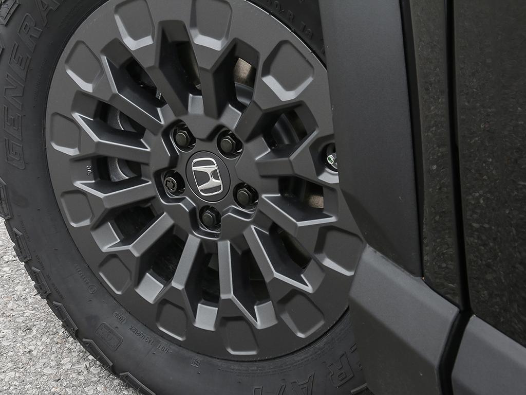 2026 Honda Passport TrailSport AWD in black, close-up of alloy wheel