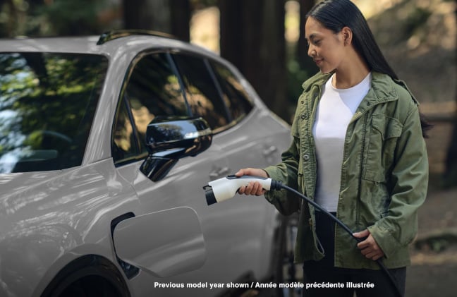 A woman charging her Honda Prologue